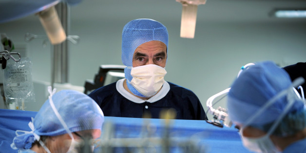 French Prime Minister Francois Fillon attends open-heart surgery on an 8 year-old child from Burkina Faso suffering from a cardiac malformation at the Georges Pompidou hospital in Paris December 17, 2007. French charity medical group "Mecenat Chirurgie Cardiaque" (MCC) uses donations to provide surgery for underprivileged children with heart problems when operations are not possible in their native country. REUTERS/Martin Bureau/Pool (FRANCE)