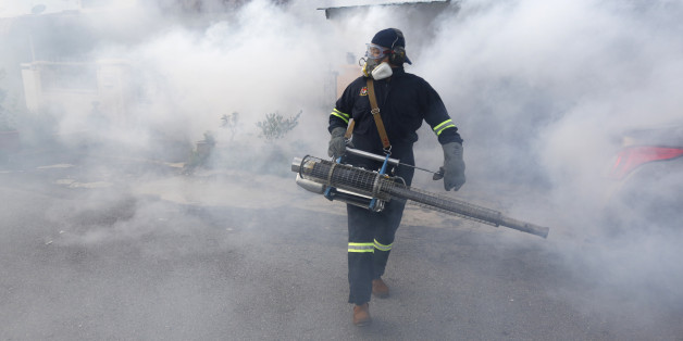 A worker from the Ministry of Health Malaysia carries out mosquito fogging at Kuala Lumpur, Malaysia, Wednesday, Sept. 14, 2016. Two new Zika virus infection cases were detected on Tuesday raising the total number of cases in the country to six. (AP Photo/Joshua Paul)