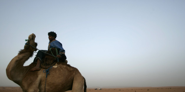 A nomad rides a camel during the IV Nomadic International Festival in M'hamid El Ghizlane, north Sahara, near Ouarzazate, March 24, 2007. The objective of the festival is to show a disappearing nomadic culture. REUTERS/Rafael Marchante (MOROCCO)