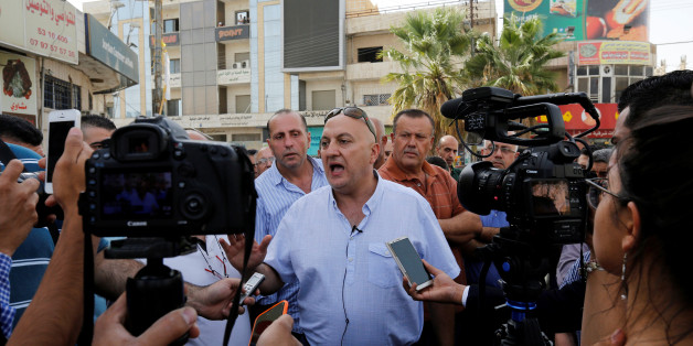 Majed Hattar (C), brother of the Jordanian writer Nahed Hattar, speaks to the media during a sit-in in the town of Al-Fuheis near Amman, Jordan, September 25, 2016. REUTERS/Muhammad Hamed