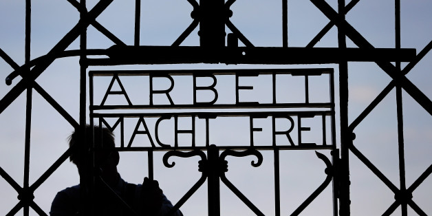 A blacksmith prepares a replica of the Dachau Nazi concentration camp gate, with the writing "Arbeit macht frei" (Work Sets you Free) at the main entrance of the memorial in Dachau, Germany, Wednesday, April 29, 2015. The gate was stolen in November 2014. (AP Photo/Matthias Schrader)