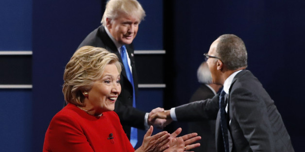Democratic U.S. presidential nominee Hillary Clinton greets supporters as Republican U.S. presidential nominee Donald Trump greets moderator Lester Holt (R) after their first presidential debate at Hofstra University in Hempstead, New York, U.S., September 26, 2016. REUTERS/Brian Snyder
