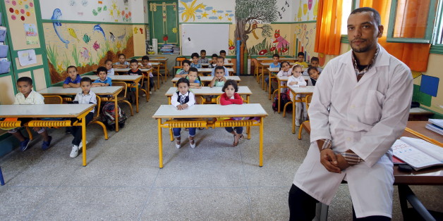 Teacher Moulay Ismael Lamrani poses for a picture with his class in the Oudaya primary school in Rabat, September 15, 2015, at the start of the new school year in Morocco. Nearly three years after Taliban gunmen shot Pakistani schoolgirl Malala Yousafzai, the teenage activist last week urged world leaders gathered in New York to help millions more children go to school. World Teachers' Day falls on 5 October, a Unesco initiative highlighting the work of educators struggling to teach children ami