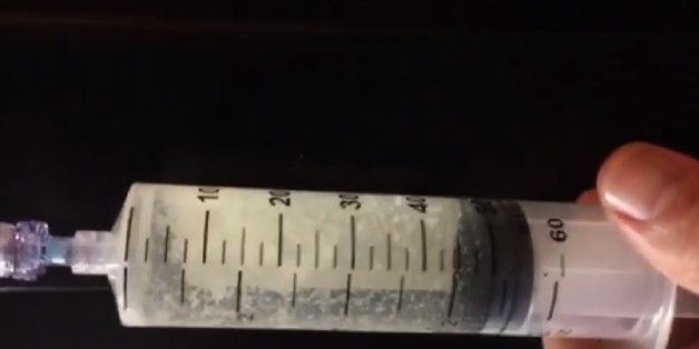 In this undated image made from video and released by the Georgia Department of Corrections, shows white chunks that had formed in the lethal injection drug the state intended to use for the execution of Kelly Gissendaner, which was scheduled for March 2, 2015. The solution is supposed to be clear and when corrections officials realized the compounded pentobarbital had precipitated, they stopped the execution and temporarily suspended all executions in the state until they could investigate what went wrong with the drug.(Georgia Department of Corrections via AP)