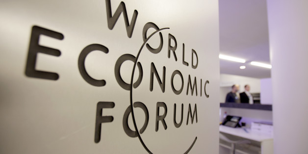 People walk by a sign in the meeting center at the World Economic Forum in Davos, Switzerland on Tuesday, Jan. 25, 2011. On the eve of the annual World Economic Forum, new reports are being released that will examine whether there is optimism about the global economy in the coming months and, perhaps more importantly, if the levels of trust in business and government are on the rebound. (AP Photo/Virginia Mayo)