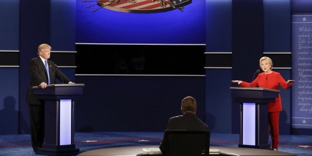 Democratic presidential nominee Hillary Clinton answers a question as Republican presidential nominee Donald Trump listens during the presidential debate at Hofstra University in Hempstead, N.Y., Monday, Sept. 26, 2016. (AP Photo/David Goldman)