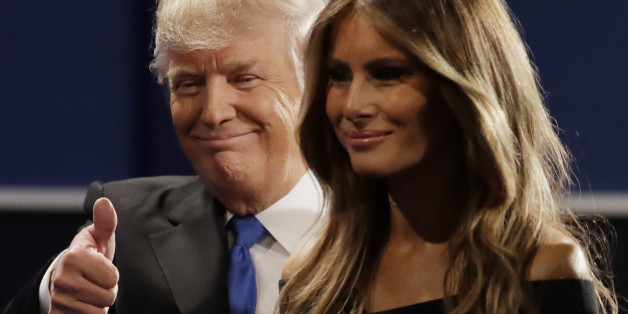 Republican presidential nominee Donald Trump walks off the stage with his wife Melania Trump, wife of Donald Trump following the presidential debate with Democratic presidential nominee Hillary Clinton at Hofstra University in Hempstead, N.Y., Monday, Sept. 26, 2016. (AP Photo/Julio Cortez)