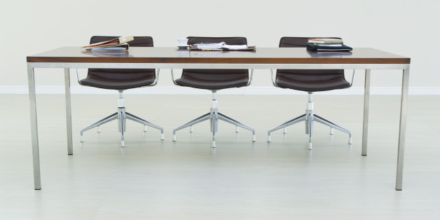 Empty chairs at conference table