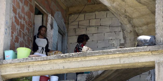 Sub-Saharan women climb the stairs in a makeshift building where they live with other fellow migrants in impoverished conditions, on May 29, 2016, in the capital Algiers. In the past, Algeria was a land of emigration, millions of its citizens exiled to France, but in recent years it has become a destination country for many West Africans. Nigerians, Malians, Cameroonians, brave the horrors of the Sahara to find refuge in the largest country in Africa, as the crossing to Europe is proving to be