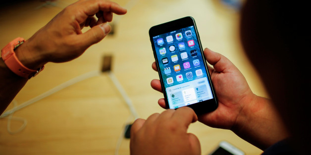 Customers take a look of the new iPhone 7 smartphone inside the Apple Inc. store in New York, U.S., September 16, 2016. REUTERS/Eduardo Munoz