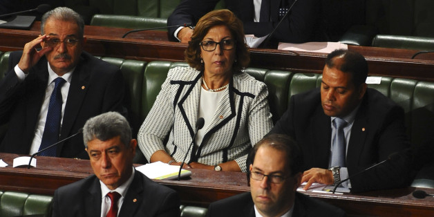 New Tunisian Finance Minister Lamia Zribi, center top, sits with Tunisian Prime Minister Youssef Chahed, right front row, at the Parliament in Tunis, Friday Aug. 26, 2016 ahead of a confidence vote. Chahed, 41, was minister for local affairs in the government of Habib Essid that fell last month. (AP Photo/Riadh Dridi)