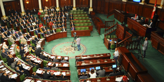 Tunisian parliament members gather during the inaugural session of the newly elected Tunisian parliament in Tunis, Tuesday, Dec. 2, 2014. This is the first national assembly meeting since the October 2014 legislative elections that resulted in a victory for opposition secular parties. (AP Photo/Hassene Dridi)