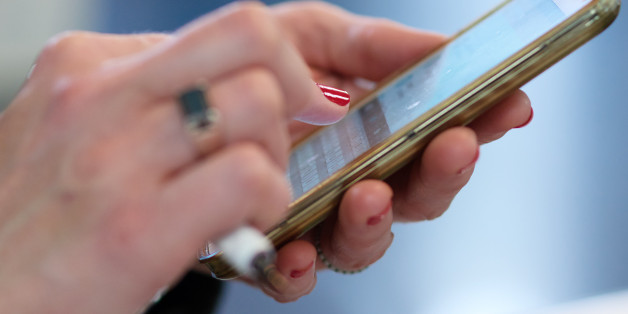 Cropped shot of an unidentifiable businesswoman using her smartphone in the office