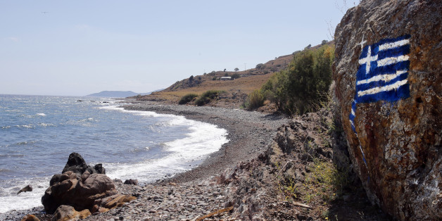 SKALA KAMINASI, GREECE - 19 JULY: A Greek flag painted on rocks can be seen on the beach of Skala Kaminas which was used by refugees to cross Aegean sea from Turkey to Greece last year on July 19, 2016 in Skala Kaminas, Lesvos Island, Greece.The increase in refugees arriving on the island of Lesvos last year has seriously effected tourism, with the number of tourists falling more than 70% this year so far. (Photo by Milos Bicanski/Getty Images)