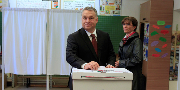 Hungary's Prime Minister Viktor Orban casts his ballot next to his wife Aniko Levai inside a polling station during a referendum on EU migrant quotas in Budapest, Hungary, October 2, 2016. REUTERS/Bernadett Szabo