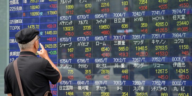 An investor watches a share prices board in Tokyo on September 9, 2015. Japan's share prices rose nearly 5 percent at the Tokyo Stock Exchange, on the back of a jump on Wall Street and on volatile Chinese bourses. AFP PHOTO / Yoshikazu TSUNO (Photo credit should read YOSHIKAZU TSUNO/AFP/Getty Images)