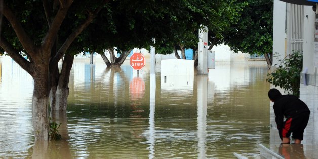 A kid plays in front of his flooded house, in the northern Tunisia village of Houcine, invaded with floodwater on November 2, 2011 near Majaz al Bab in Beja's province. It has been three days since the rain has not stopped in Tunisia and already killed three people in the governorate of Zaghouan. AFP PHOTO/ FETHI BELAID (Photo credit should read FETHI BELAID/AFP/Getty Images)