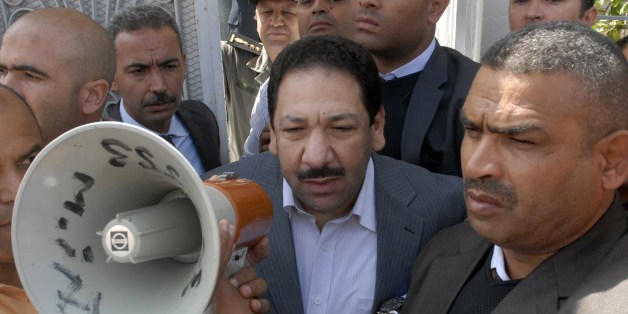 Tunisian Interior Minister Lotfi Ben Jeddou (C) arrives at his home on May 28, 2014 in Kasserine, located at the foot of Mount Chaambi on a range bordering Algeria, after four Tunisian police officers were killed during an attack overnight at his family house. Suspected Islamist gunmen killed four policemen at the family home of Tunisia's interior minister, officials said,describing it as a 'revenge' attack for progress in the fight against jihadists. AFP PHOTO / KANTOULA (Photo credit should read KANTOULA/AFP/Getty Images)