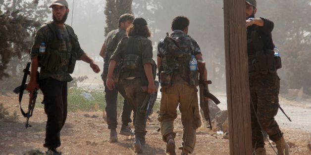 Fighters from the former Al-Nusra Front -- renamed Fateh al-Sham Front after breaking from Al-Qaeda -- advance at an armament school after they announced they seiged control of two military academies and a third military position on August 6, 2016, the Syrian Observatory for Human Rights said. Jabhat Fateh al-Sham announced having captured two military academies and a third military position as they seized key poisitions south of Aleppo in a bid to break the government siege of the city. / AFP