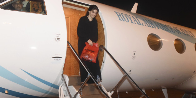 In this photo released by the Oman News Agency on Tuesday, Oct. 4, 2016, Nourane Houas who was kidnapped by a group of armed men in Yemen on Dec. 1, 2015, arrives at Muscat airport, Oman, after being released in Yemen. The French-Tunisian woman working for the Red Cross has been released after nearly a year in captivity in Yemen, the International Committee of the Red Cross said late Monday. (Oman News Agency via AP)