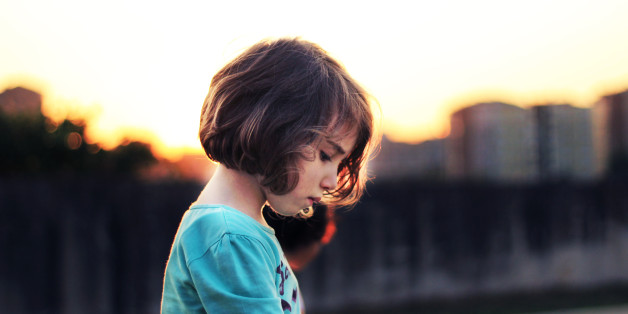 Young girl indoors crying