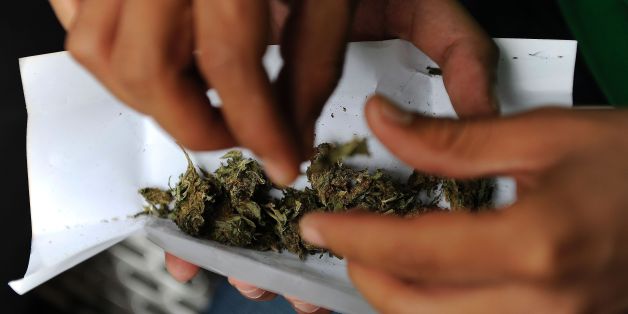 A man rolls a joint during a demonstration demanding the approval of the use of marijuana for medicinal and recreational purposes in front of the Mexican Senate building in Mexico City on September 28, 2016. / AFP / PEDRO PARDO (Photo credit should read PEDRO PARDO/AFP/Getty Images)