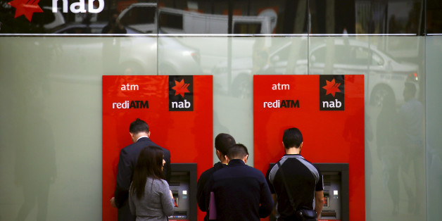Customers withdraw money from National Australia Bank (NAB) Automatic Teller Machines (ATMs) in central Sydney, Australia, July 24, 2015. REUTERS/David Gray/File photo