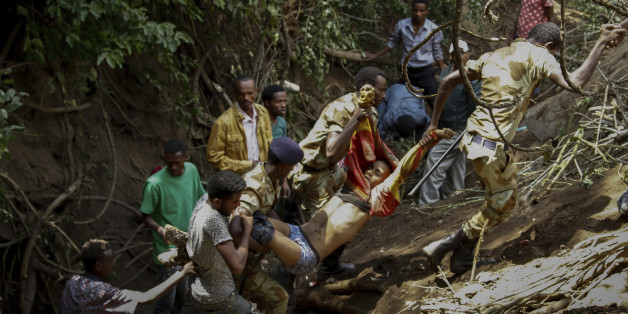 In this photo taken on Sunday, Oct. 2, 2016, soldiers and civilians carry an injured man to safety after a stampede in Bishoftu, Ethiopia. Violence flared again Monday in Ethiopia's restive Oromia region, where dozens of people were killed a day earlier in a stampede when police tried to disrupt an anti-government protest amid a massive religious festival. Clashes between security forces and protesters erupted Sunday evening and continued Monday morning in the towns of Bishoftu and Ambo, an Ethiopian government official and witnesses told The Associated Press. (AP Photo)