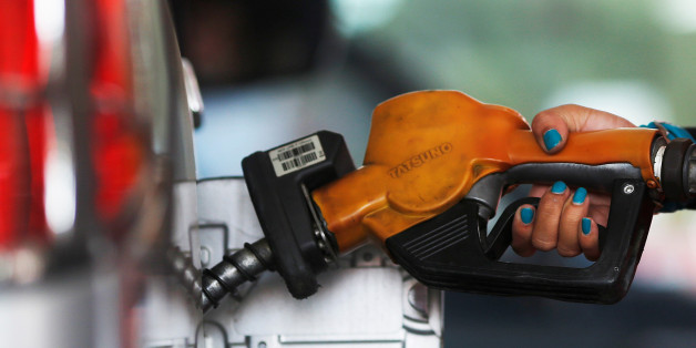 A worker at state-owned Pertamina, the country's main retailer of subsidised fuel, fills a vehicle at a petrol station in Jakarta November 17, 2014. REUTERS/Beawiharta/File Photo