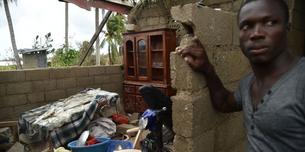 Stanley stands in his destroyed house after the passing of Hurricane Matthew, in Les Cayes, in Southwest Haiti, on October 6, 2016.The storm killed at least 108 people in Haiti, the poorest country in the Americas, with the final toll expected to be much higher. / AFP / HECTOR RETAMAL (Photo credit should read HECTOR RETAMAL/AFP/Getty Images)