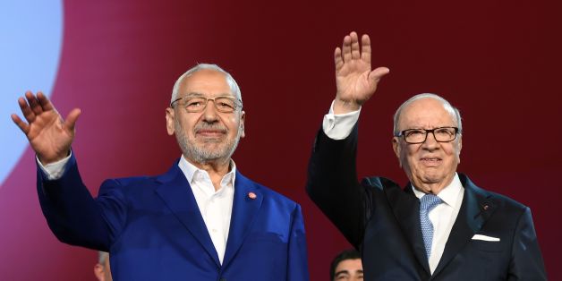 Tunisian president Beji Caid Essebsi (R) and Islamist Ennahdha Party leader Rached Ghannouchi (L) wave to the crowd on May 20, 2016 at the opening of Ennahdha's three-day congress in Tunis.
Thousands of people attended the opening ceremony of the congress -- the first since 2012 -- held at a sports complex in Rades, south of the capital Tunis, amid heavy police security. / AFP / FETHI BELAID (Photo credit should read FETHI BELAID/AFP/Getty Images)
