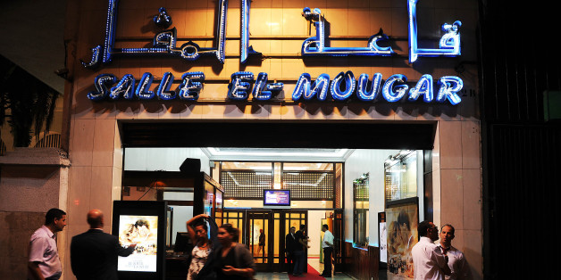 Algerians walk outside the Salle el-Mougar during the world premiere of 'Ce que le jour doit à la nuit' (What the Day Owes the Night) in Algiers on September 7, 2012. The film, which is based on a novel by Algerian writer Yasmina Khadra, is directed by French filmmaker Alexandre Arcady. AFP PHOTO/FAROUK BATICHE (Photo credit should read FAROUK BATICHE/AFP/Getty Images)