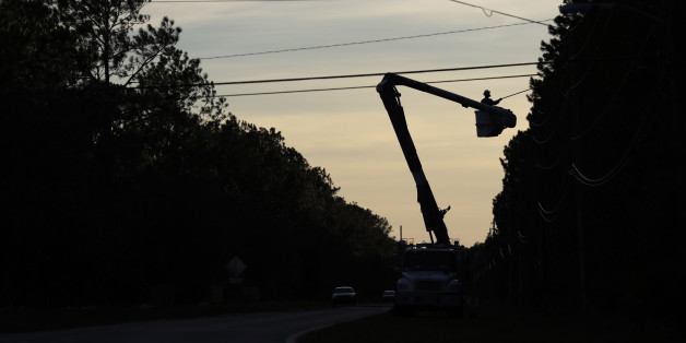 Crews remove limbs from power lines after winds from Hurricane Matthews hit the area, Saturday, Oct. 8, 2016, in Flagler Beach, Fla. Thousands of residents and businesses are with out power. (AP Photo/Eric Gay)