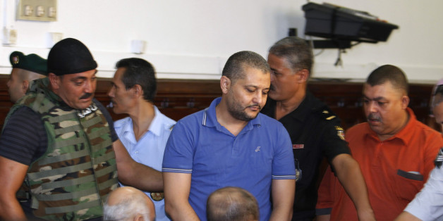 Imed Trabelsi (C), a nephew of ousted Tunisian President Zine al-Abidine Ben Ali, arrives for a third trial hearing at a court in Tunis August 10, 2011. The trial of 23 relatives and allies of Ben Ali, charged with trying to illegally flee the country, resumed on Wednesday. REUTERS/Zoubeir Souissi (TUNISIA - Tags: POLITICS CRIME LAW)