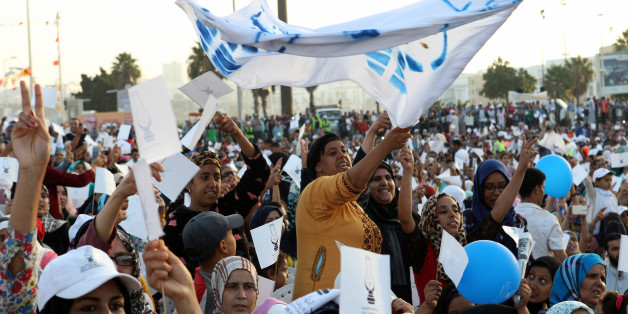 Supporters hold flag of Islamist Justice and Development Party, known as the PJD, during a campaign rally in Sale near Rabat, Morocco Thursday, October 6, 2016. Voting booths open on Friday Oct. 7 for the North African kingdom's parliamentary elections, in which 395 seats in the upper house of Parliament are up for grabs, more than 15 million Moroccans are registered to vote in the upcoming legislative elections. (AP Photo/Abdeljalil Bounhar)