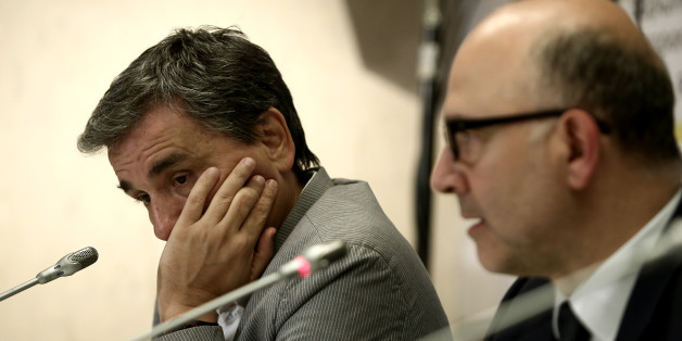 Greek Finance Minister Euclid Tsakalotos (L) during a joint press conference with Pierre Moscovici, European Commissioner for Economic and Financial Affairs, Taxation and Customs, at the European Commission offices in Athens, Greece on July 18, 2016 (Photo by Panayiotis Tzamaros/NurPhoto via Getty Images)