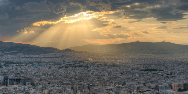 Rays of sunlight breaking through dramatic clouds over Athens, Greece