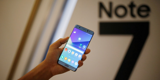 A model poses for photographs with a Galaxy Note 7 new smartphone during its launching ceremony in Seoul, South Korea, August 11, 2016. REUTERS/Kim Hong-Ji/File Photo TPX IMAGES OF THE DAY