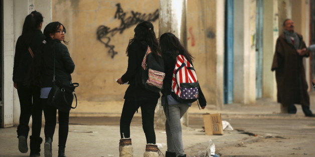 Students walk to their houses at the impoverished Zhor neighborhood of Kasserine, where young people have been demonstrating for jobs since last week, January 28, 2016. REUTERS/Zohra Bensemra