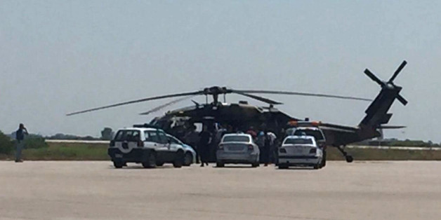 Greek policemen check a Turkish Blackhawk helicopter after landing at the airport of Alexandroupolis, northeastern Greece, on Saturday, July 16, 2016. Greece's defense ministry says a Blackhawk military helicopter carrying seven Turkish military personnel and one civilian has landed at the airport in the city of Alexandroupolis in northeastern Greece. The passengers have asked for asylum. They were arrested for illegal entry into Greece. (E-evros.gr via AP)