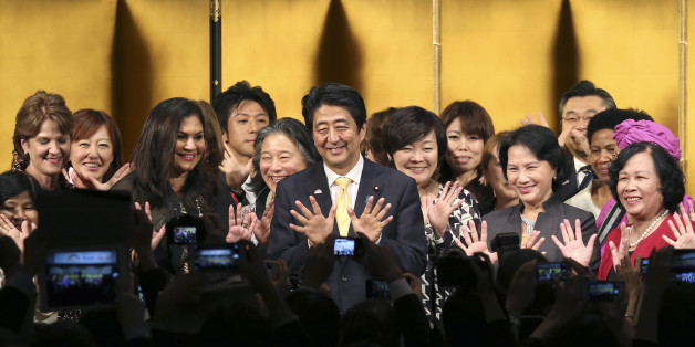Japanese Prime Minister Shinzo Abe, center, poses for a photo with participants during a reception of WAW!, or the World Assembly for Women, in Tokyo, Friday, Aug. 28, 2015. More than 100 people from about 40 countries participated in the open forum for women. Japanese lawmakers approved a law Friday requiring large employers to set and publicize targets for hiring or promoting women as managers. The law approved by a vote of 230-1 in the House of Councillors is intended to promote greater gende
