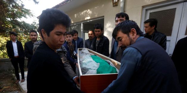 Afghan men carry the dead body of a civilian at a hospital after gunmen attacked a shrine in Kabul, Afghanistan October 12, 2016. REUTERS/Omar Sobhani
