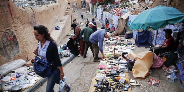 People look for items at a small flea market behind Bab el Bahr gates of Rabat's Medina September 21, 2014. UNESCO made Rabat a World Heritage Site two years ago and media and tour operators call it a "must-see destination." But it seems the tourist hordes have yet to find out. While visitors are getting squeezed through the better-known sites of Marrakesh and Fez, the old part of Rabat - with its beautiful Medina and Kasbah of the Udayas - remains an almost unspoiled oasis of calm. Smaller an