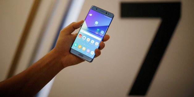 A model poses for photographs with a Galaxy Note 7 new smartphone during its launching ceremony in Seoul, South Korea, August 11, 2016. REUTERS/Kim Hong-Ji/File Photo TPX IMAGES OF THE DAY
