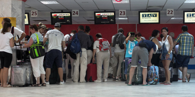 Tourists line up at Monastir airport as they prepare to leave Tunisia, a day after a shooting attack which took place in the coastal town of Sousse Saturday, June 27, 2015. Tunisia's prime minister announced on Saturday a string of new security measures including closing renegade mosques and calling up army reservists as thousands of tourists fled the North African country in wake of its worst terrorist attack ever. Tourists crowded into the airport at Hammamet near the coastal city of Sousse wh