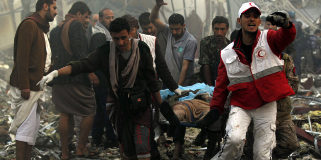 Yemeni rescue workers carry a victim on a stretcher amid the rubble of a destroyed funeral hall building following reported airstrikes by Saudi-led coalition air-planes on the capital Sanaa on October 8, 2016.Rebels in control of Yemen's capital accused the Saudi-led coalition fighting them of killing or wounding dozens of people in air strikes on Sanaa. The insurgent-controlled news site sabanews.net said that coalition planes hit a building in the capital where people had gathered to mourn the