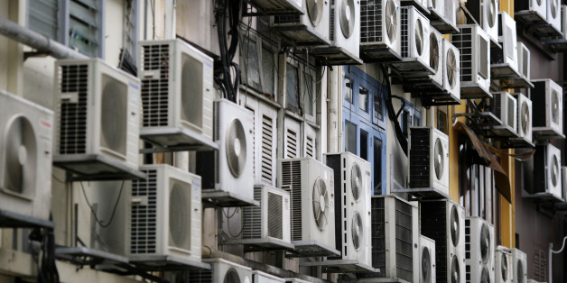 Rows of air conditioners are seen on the walls of a building in Singapore's financial district December 11, 2009. REUTERS/Vivek Prakash (SINGAPORE ENVIRONMENT ENERGY POLITICS)