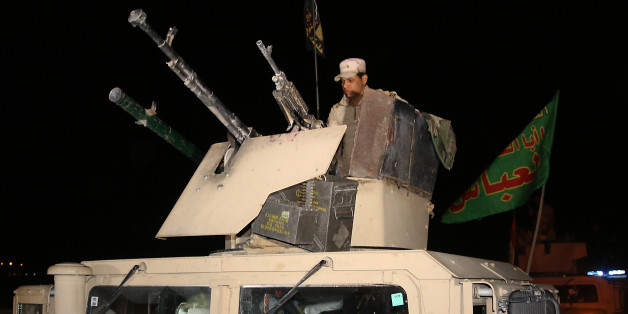 Iraqi army soldiers drive through the city of Kirkuk on October 10, 2016 as they head to the frontline in preparation for the battle to retake the city of Mosul. The battle to retake the Iraqi city of Mosul from jihadists could unleash a major humanitarian crisis, potentially pushing hundreds of thousands to flee their homes as winter sets in. Mosul, the country's second city, was seized by the Islamic State group in 2014, and is now the last major population centre still held by the jihadists,