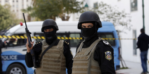 Police officers guard the entrance of the National Bardo Museum a day after gunmen opened fire killing scores of people in Tunis, Thursday, March 19, 2015. One of the gunmen who killed tourists and others at a prominent Tunisian museum was known to intelligence services, but no formal links to a particular extremist group have been established, the prime minister said Thursday. (AP Photo/Christophe Ena)