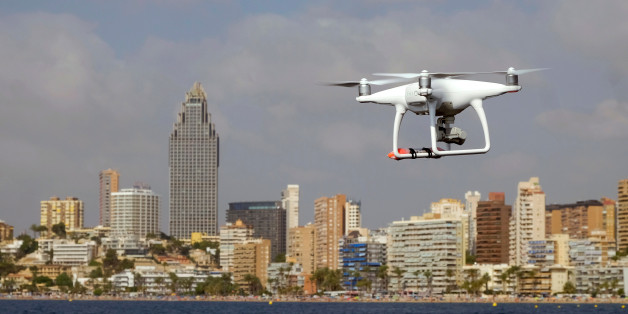 A drone, equipped with a camera used by police for surveillance tasks, flies in front of Poniente beach at the eastern costal town of Benidorm, Spain, August 18, 2016. REUTERS/Heino Kalis